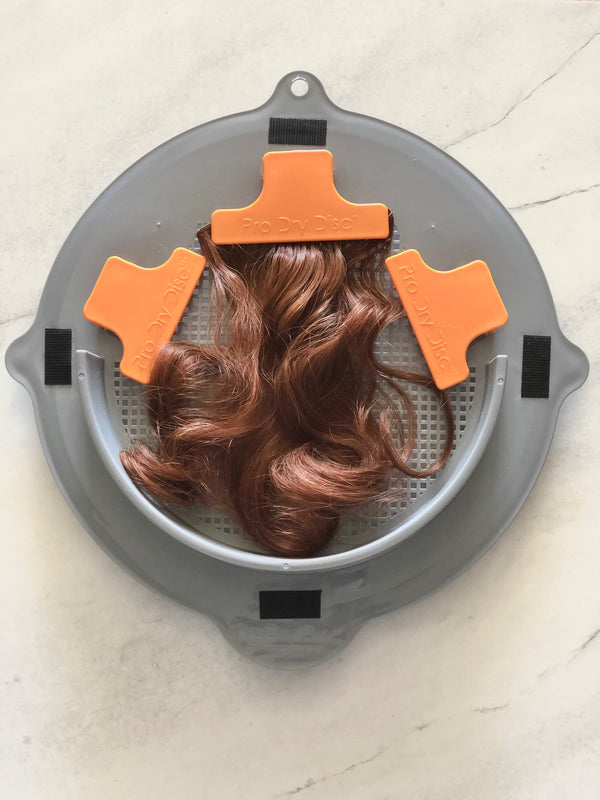 Hairpiece secured on ProDry Disc with orange clips