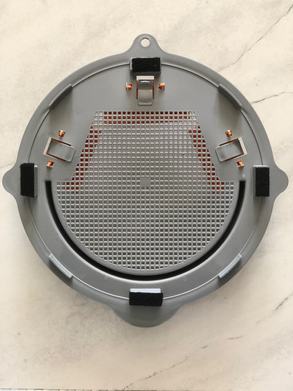 Underside of ProDry Disc showing mesh base and clip fastenings